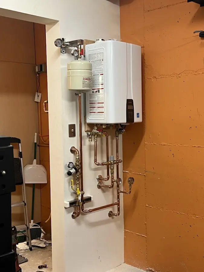 Plumbing technician inspecting water heater connections in Halifax